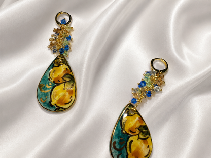 Pair of handmade Sicilian drop earrings with hand-painted Caltagirone ceramic lemon motifs, gold lustre and blue Swarovski crystals