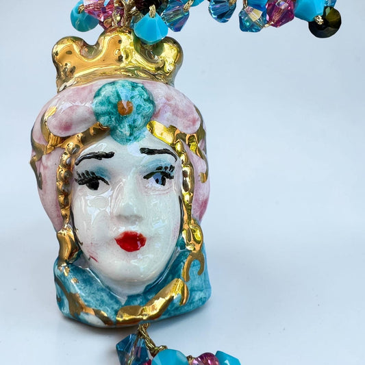 Close-up of hand-painted Caltagirone ceramic Moor’s Head pendant on a handmade Sicilian bracelet