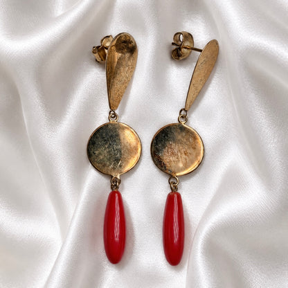 Sardinian red coral and 925 silver earrings on white satin, showing gold-tone discs, teardrop tops, and butterfly backs.