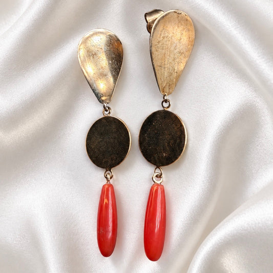 Sardinian red coral and 925 silver drop earrings with gold-tone teardrop tops and round discs, displayed on white satin.