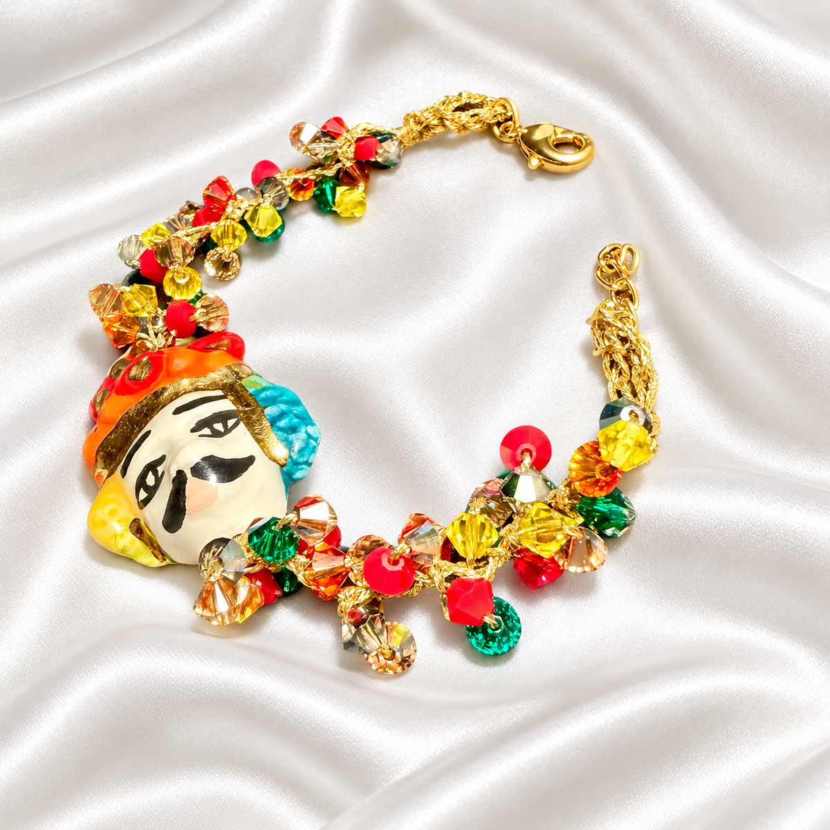Handmade Sicilian bracelet with hand-painted ceramic Moor’s Head, 15% gold lustre, multicolored Swarovski crystals and gold-plated brass chain.
