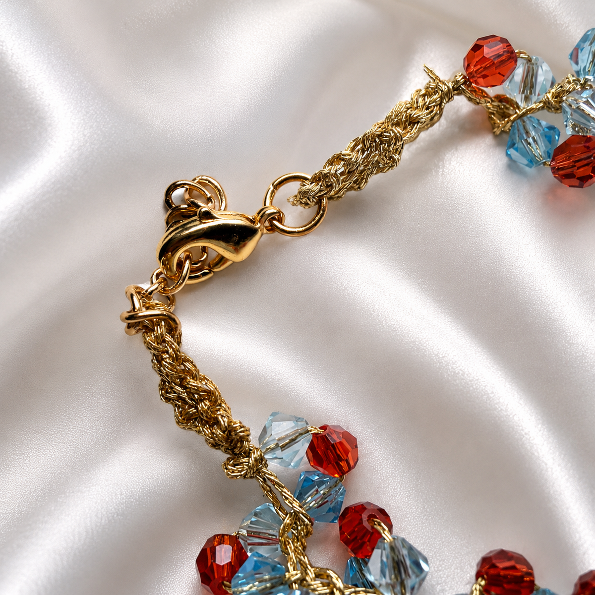 Gold-tone lobster clasp and hand-crocheted thread detail on Sicilian Swarovski crystal bracelet