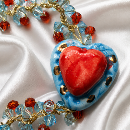 Close-up of hand-painted Caltagirone ceramic Sacred Heart with red and blue Swarovski crystals