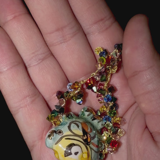 Video showing handmade Sicilian ceramic fish bracelet with multicolor Swarovski crystals held in hand