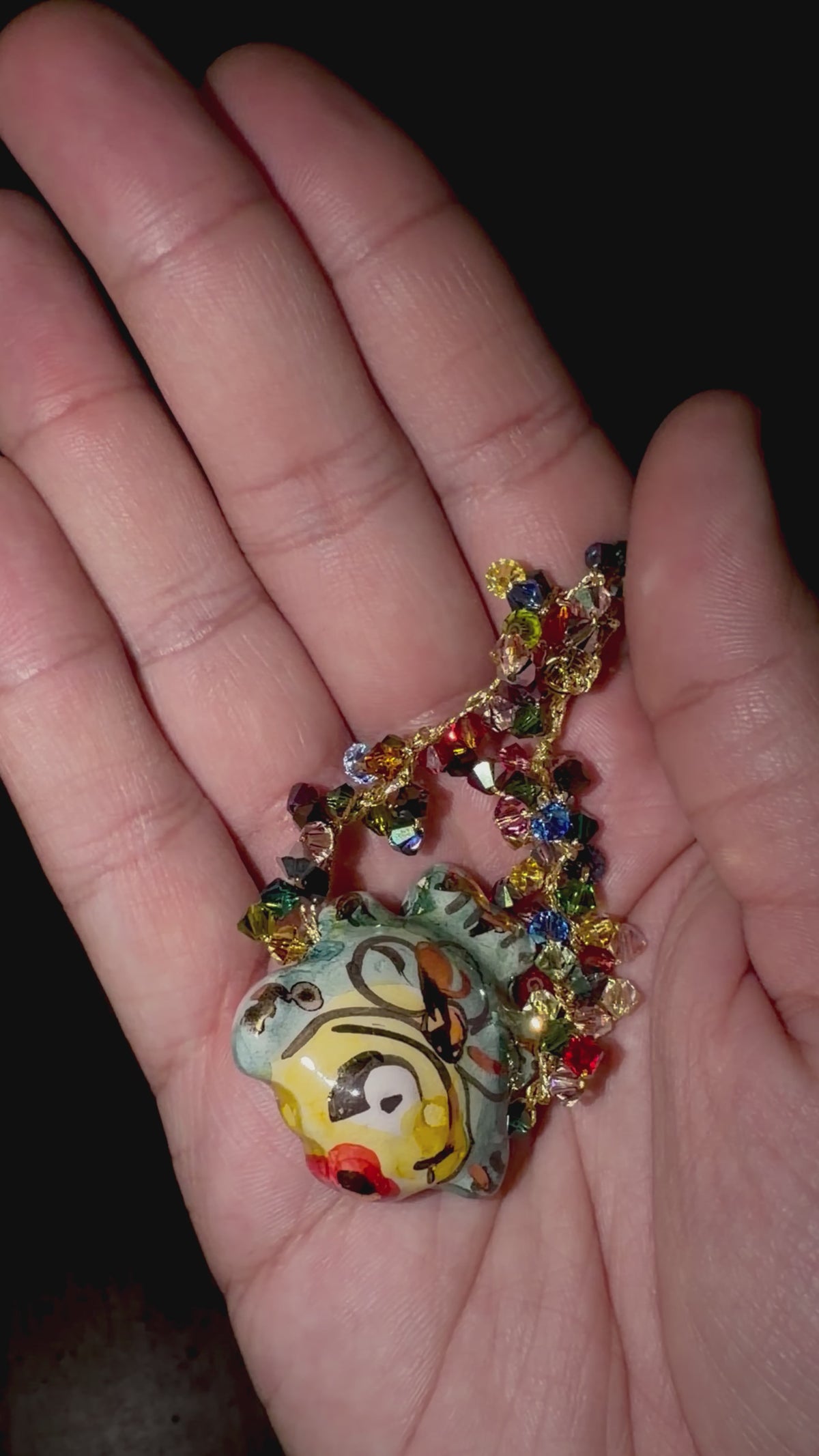 Video showing handmade Sicilian ceramic fish bracelet with multicolor Swarovski crystals held in hand