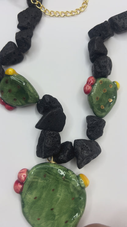 Video close-up of handmade Sicilian prickly pear pendant in hand-painted Caltagirone ceramic with Mount Etna lava stone necklace
