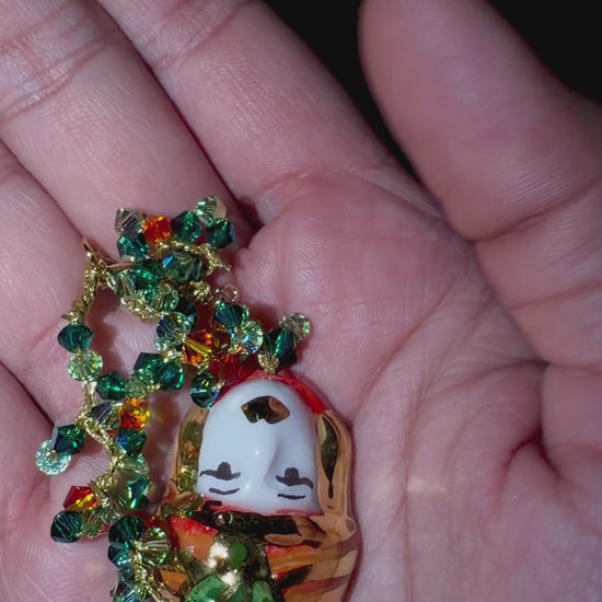 Video showing Moor’s Muse handmade Sicilian Testa di Moro bracelet with green and orange Swarovski crystals held in hand