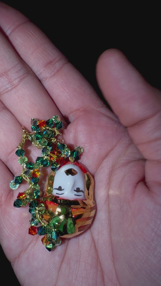 Video showing Moor’s Muse handmade Sicilian Testa di Moro bracelet with green and orange Swarovski crystals held in hand