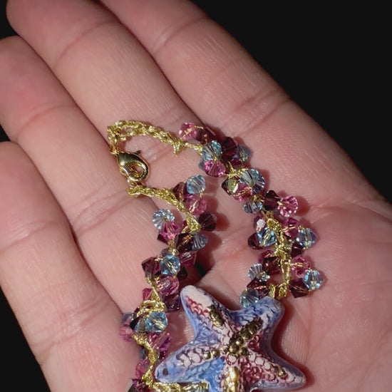 Video showing handmade Sicilian starfish bracelet with Swarovski crystals held in hand to show its size and details
