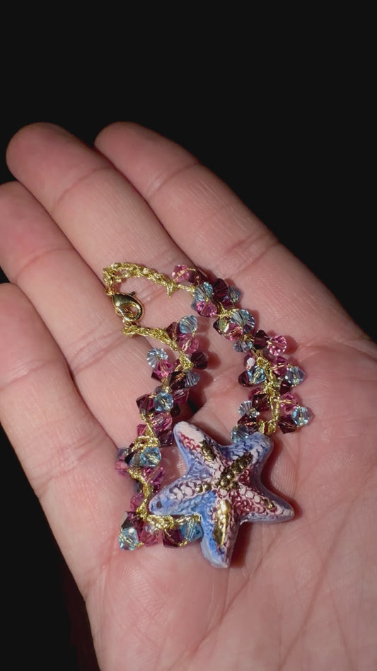 Video showing handmade Sicilian starfish bracelet with Swarovski crystals held in hand to show its size and details