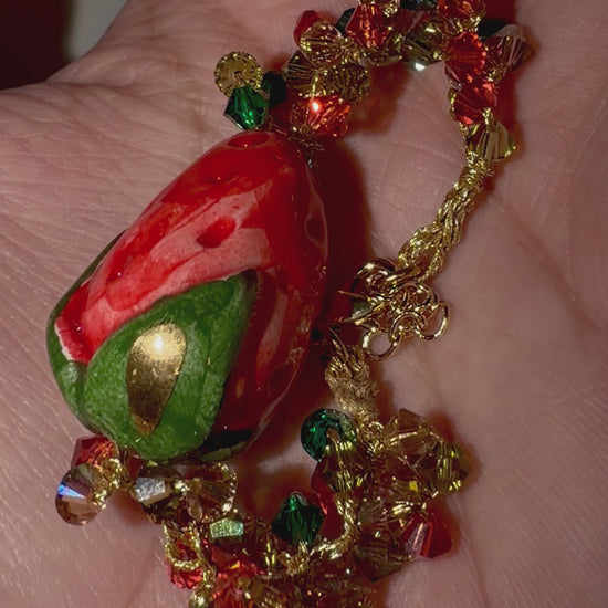 Video showing handmade Sicilian strawberry bracelet with ceramic strawberry and Swarovski crystal crochet details