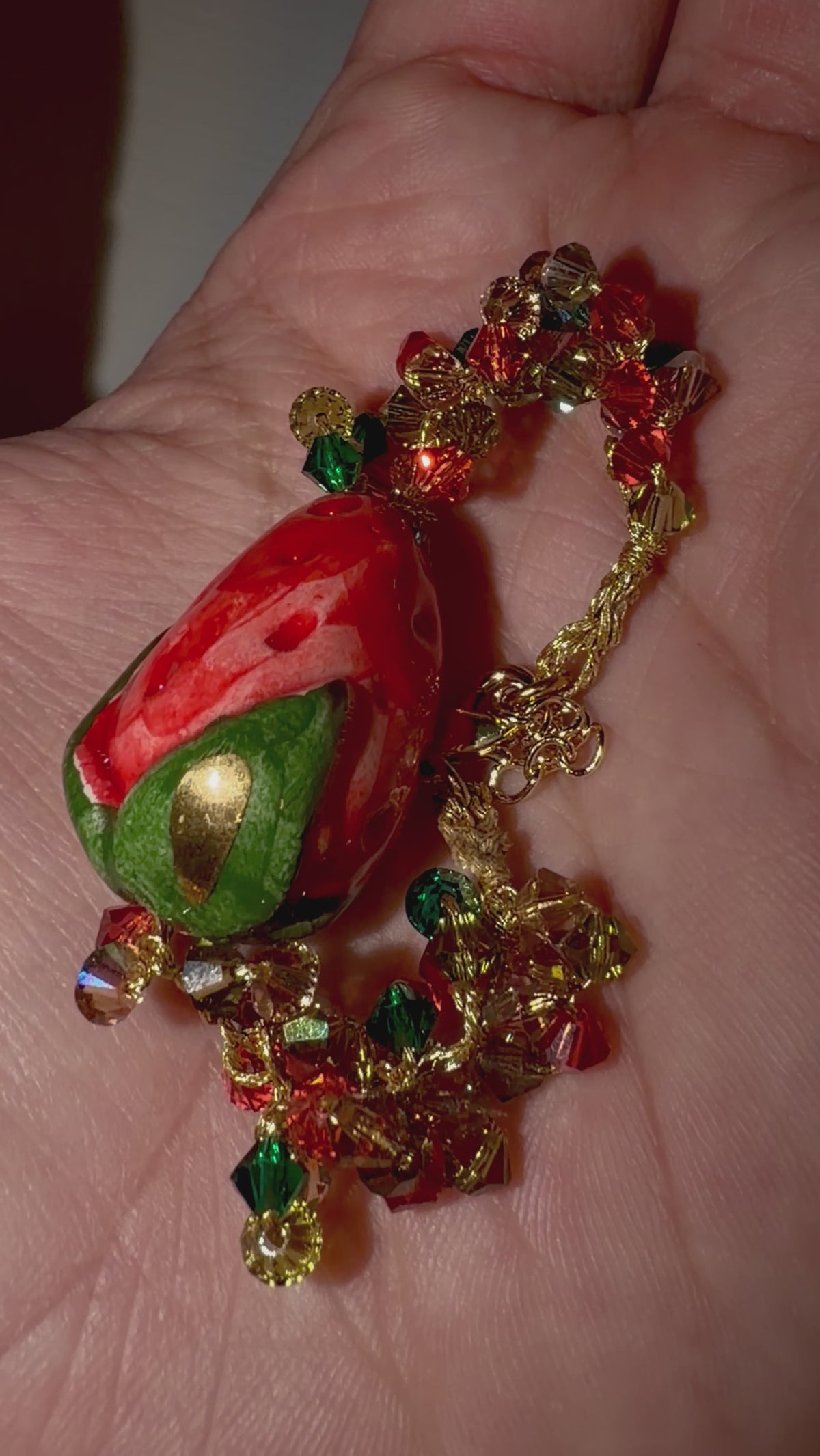 Video showing handmade Sicilian strawberry bracelet with ceramic strawberry and Swarovski crystal crochet details