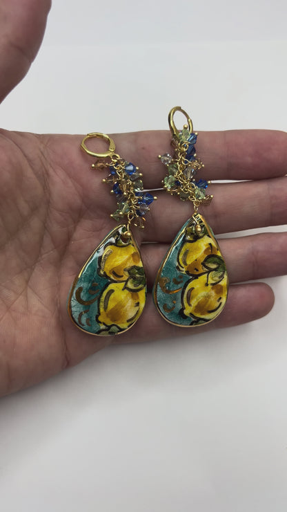 Video showing handmade Mediterranean Dawn Sicilian ceramic drop earrings with lemon motifs and Swarovski crystals held in hand